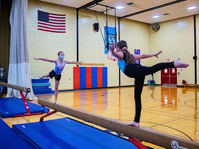 Two girls practicing gymnastics