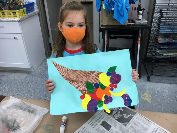 Child Holding Art